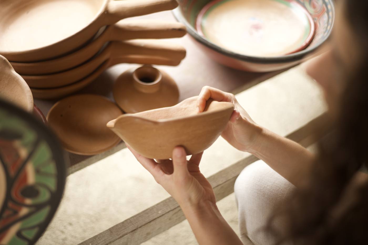 Hand-thrown clay bowl held in the workshop