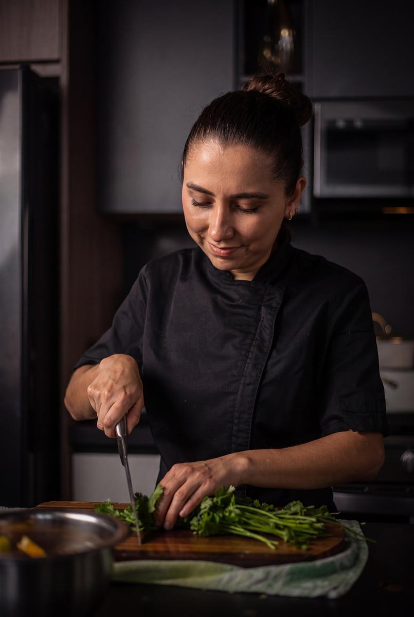 Chef Stephanie Molina preparing herbs in a private kitchen